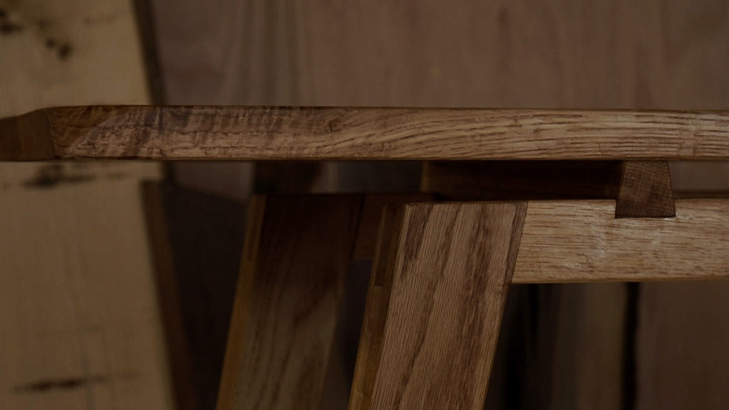 Close up of an oak console table.