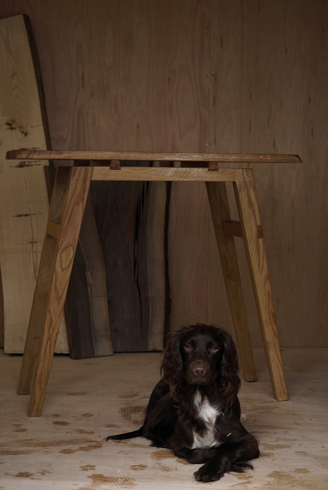 Oak console table with a dog laying underneath.