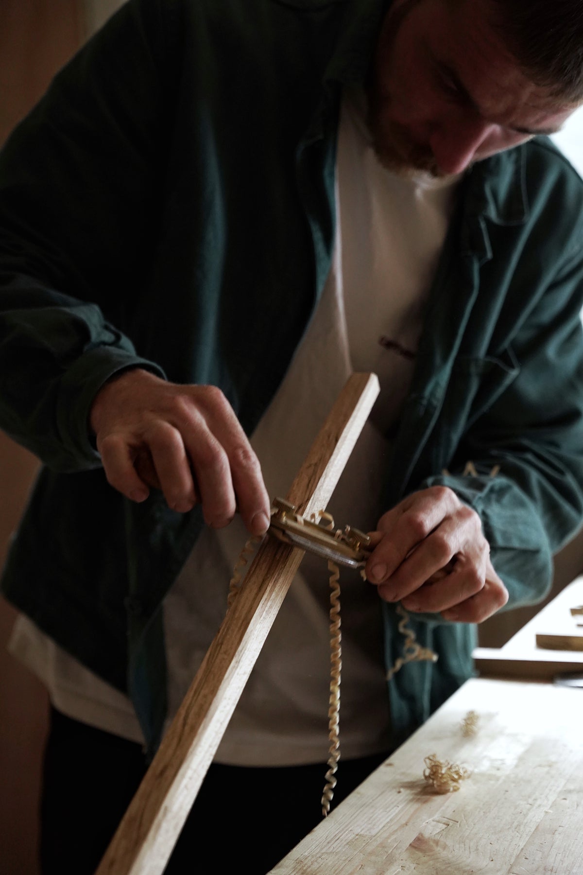 Attune work worker handmaking chair leg in stuido.