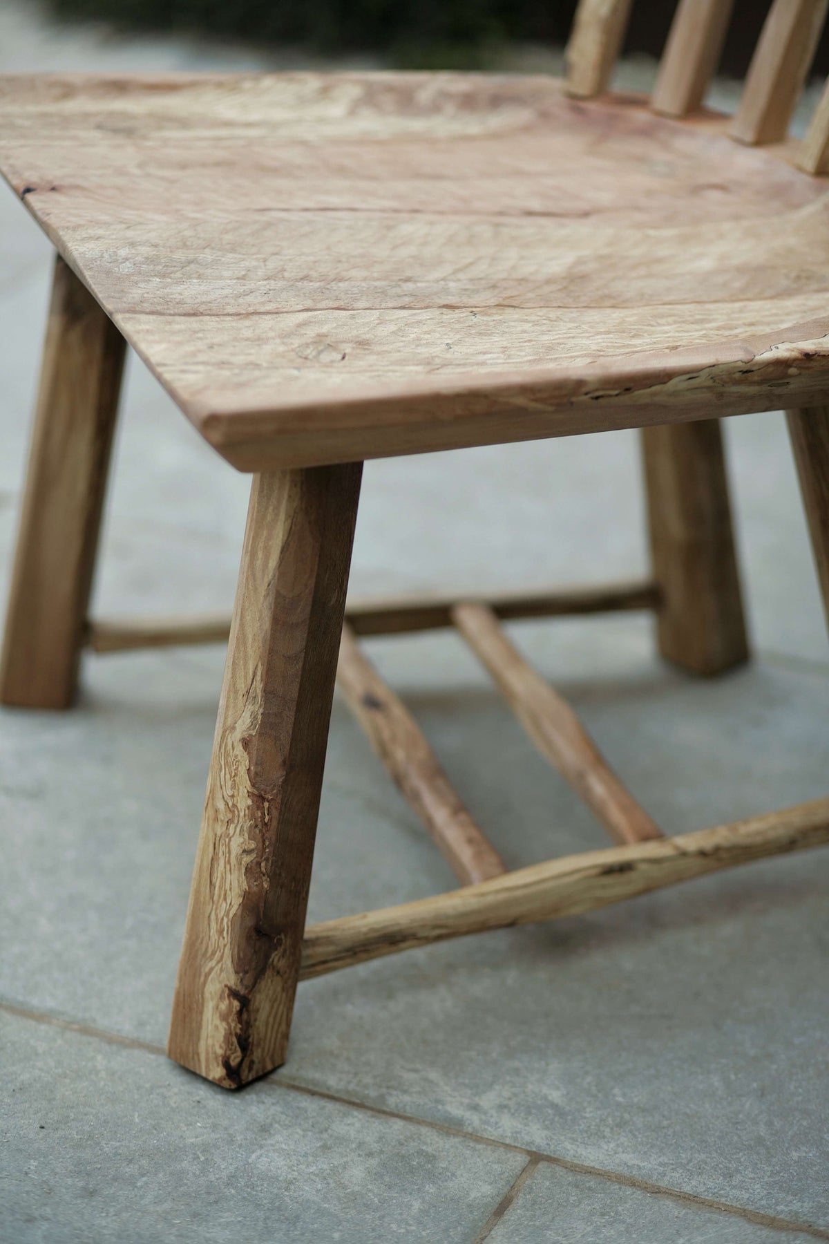 Close up of the seat and feet of a spalted beech chair.